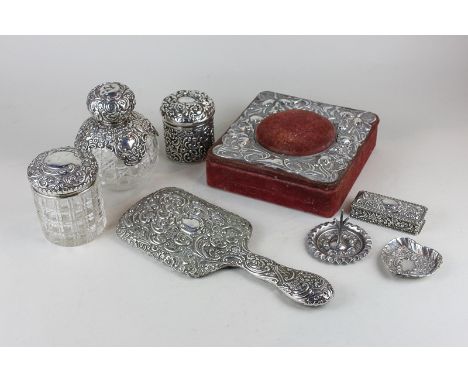 Eight Victorian and later silver and silver mounted dressing table items including a hand mirror, ring tree, travelling scent