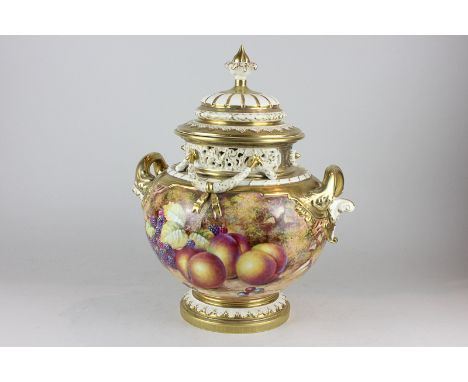 A large Royal Worcester porcelain pot pourri and cover, decorated with fruit, signed Freeman, with gilt embellishment and flo