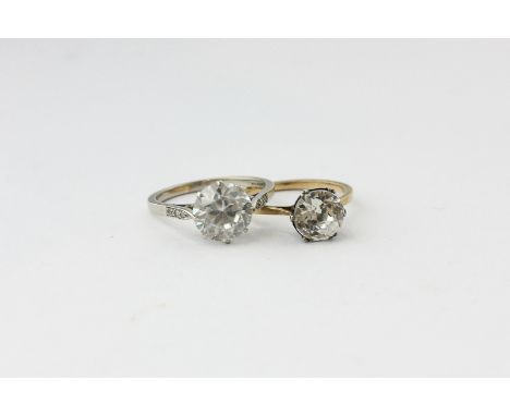 A paste set single stone ring with three single cut diamonds to each shoulder, and another similar ring