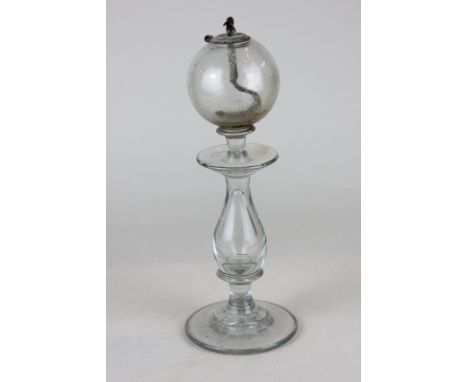 An early 19th century glass lace makers lamp with baluster stem on circular base 26cm