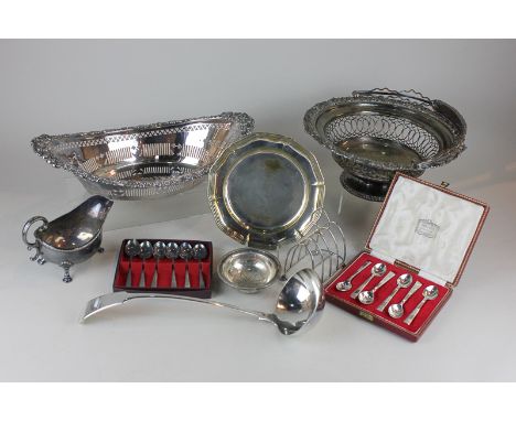 A Victorian silver plated cake basket, a silver plated ladle, toast rack and basket, two cased sets of spoons and other silve