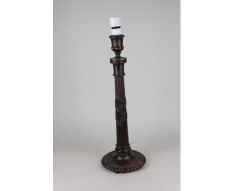 A carved mahogany table lamp, with ribbon and fluted stem on circular base, 47cm high