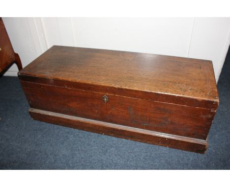 A 19th century oak trunk, with carry handles, a plinth base, 103cm