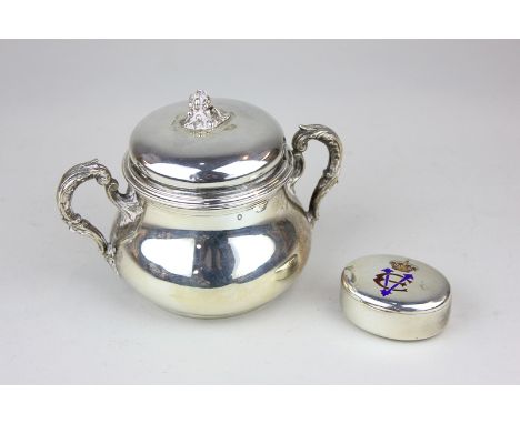 A French export silver sugar bowl and cover with floral scroll handles and finial, together with a white metal snuff box bear