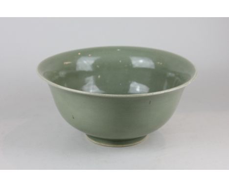 A Chinese celadon bowl with flared rim, on circular foot, blue seal mark to base (a/f), 26cm 