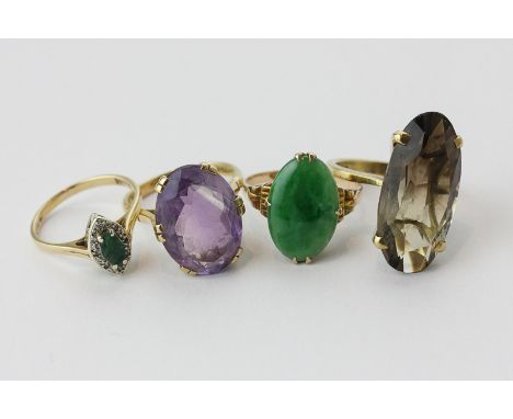 A jade ring in 14ct gold; an amethyst ring in 9ct gold; a smoky quartz ring; an emerald and diamond ring