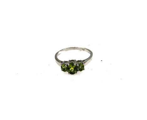 Silver dress ring with 3 graduated claw set oval peridots