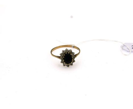 9ct gold cluster ring with oval claw set sapphire surrounded by cubic zirconia's size V