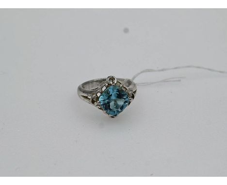 white gold stamped 525 dress ring with a large cushion shaped blue topaz size P/Q