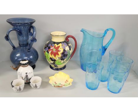 A Tuscan Decoro Pottery vase, crazed, a blue glass vase, a blue glass water jug and five glasses, one chipped, a small Carlto