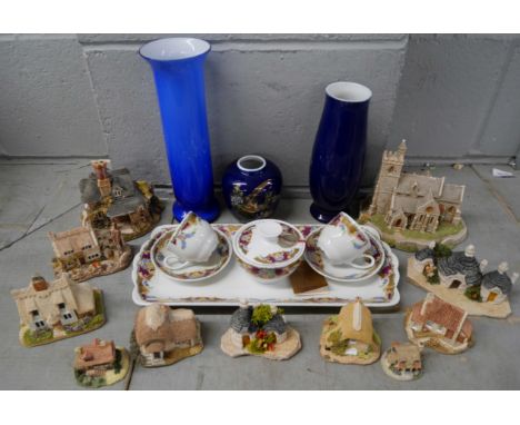 A collection of eleven Lilliput Lane Cottages and Church plus a Limoges tea set, two blue vases and a blue glass vase, three 