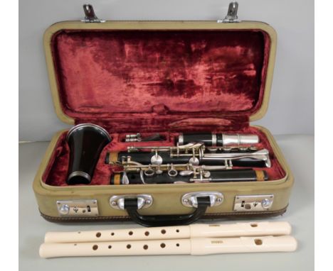 A cased clarinet and two Yamaha flutes 