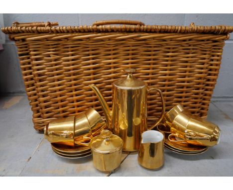 A wicker hamper containing a gold lustre tea set 