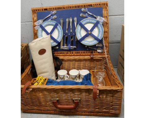 A vintage wicker picnic hamper and contents 