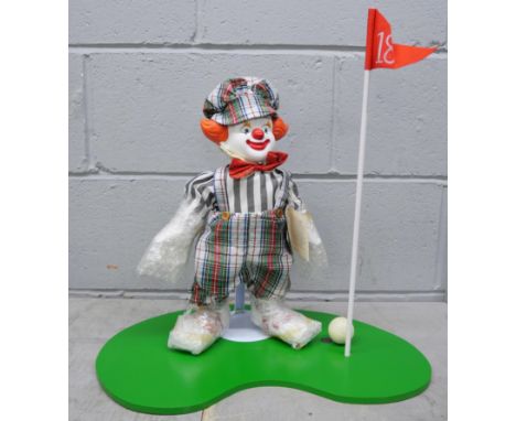 A Victoria Impex Corporation model of a clown, boxed, a doll on rocking chair and four large resin figures of children (shelf