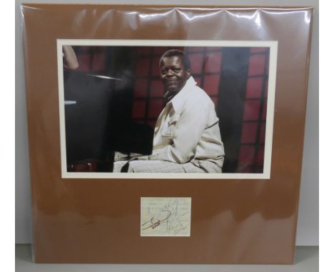 An Oscar Peterson signed ticket display, no COA