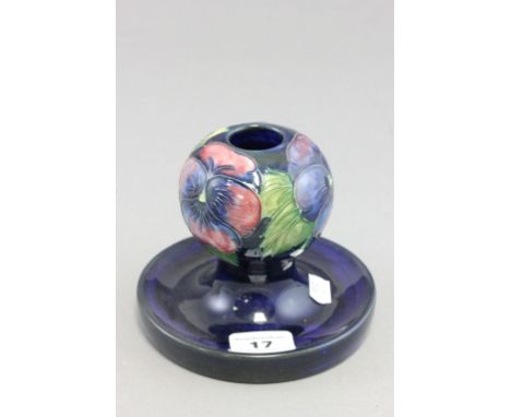 Moorcroft; a Moorcroft pottery candlestick in the Pansy pattern; bearing impressed and script mark to base