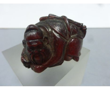 A Chinese amber style netsuke bearing signature to base