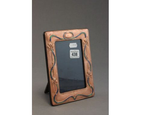 An art nouveau style copper & enamel easel back picture frame