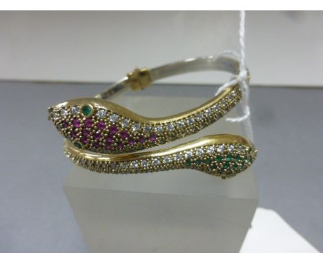 A silver double snake bangle inset with semi-precious stones