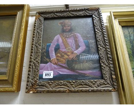 An ornate framed oil painting portrait of a Maharaja
