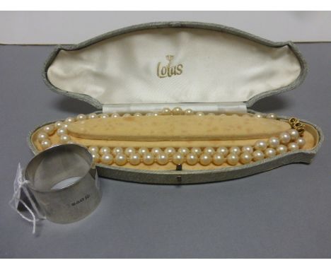 Boxed lotus simulated pearl necklace plus a hallmarked silver napkin ring