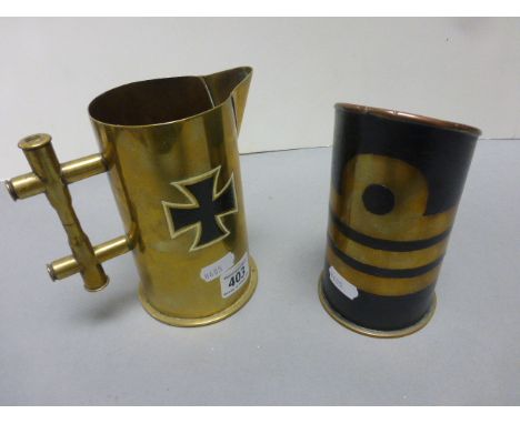 Two Trench Art brass jugs made from shells, one with fleet air arm enamel badge, the other with WWI German iron cross decorat