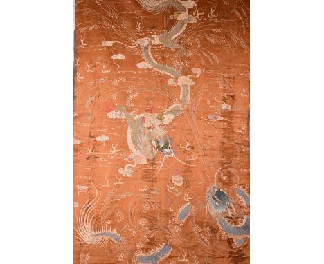 Large C19th Chinese embroidery decorated with a pair of confronted dragons chasing a flaming pearl reserved on an orange grou