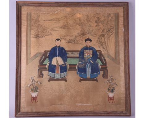 C19th Chinese ancestor portrait, painted with a Civil Official and his consort seated on a couch-bed, mounted and framed, 77 