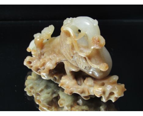 Chinese jade carving of a bird with flowering leafage, 6cm H, 9cmL
