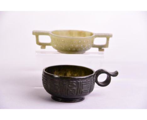 Chinese celadon jade archaistic two-handled cup, the body carved with a band of bosses, 11.6cm long; together with a dark spi