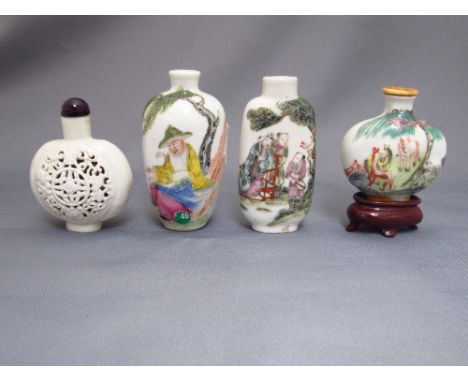 Two Chinese porcelain famille rose scent bottles with figural decoration, painted marks in red a pottery white glazed reticul
