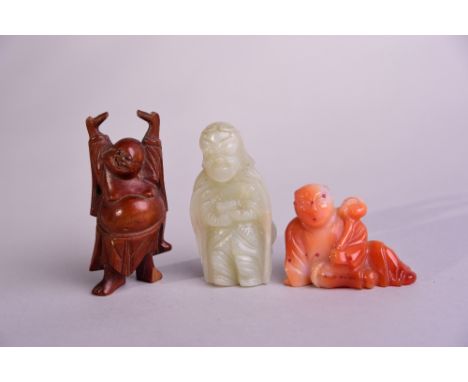 Chinese wood carving of Luohan, 7.8cm high; together with a jade figure, and a carved agate boy holding a ruyi (3) 
