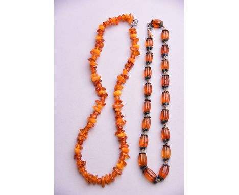 C19th Chinese enamel and silver-embellished amber necklace, 40cm long; together with another amber necklace (2) 