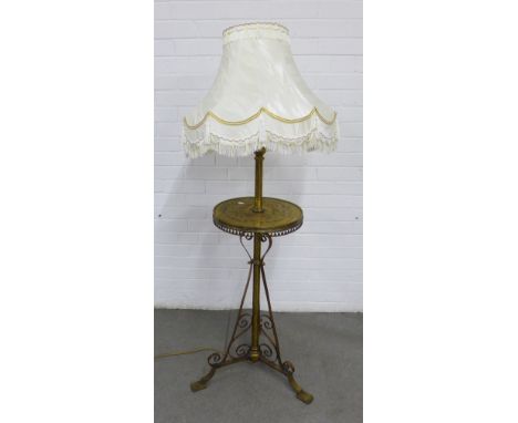 Brass and copper standard lamp with integral table, on scrolling tripod legs, complete with shade, 115cm to fitting.