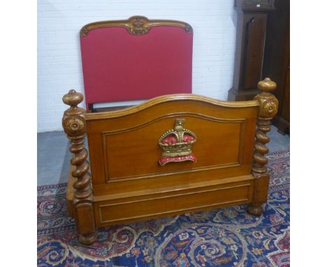 Oak bed, the headboard with a coronet crown and acorn leaf carving and red upholstery, the footboard with curved top and flan