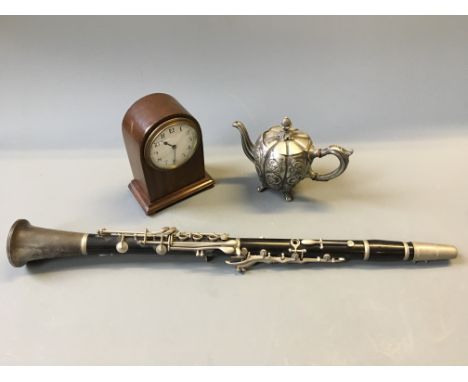 A mahogany mantle clock, clarinet and white metal pumpkin shaped teapot.