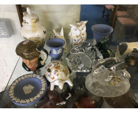 A collection of various items including blue and white Wedgwood, Royal Foulton The Poacher, glass clock in form of dolphin, A