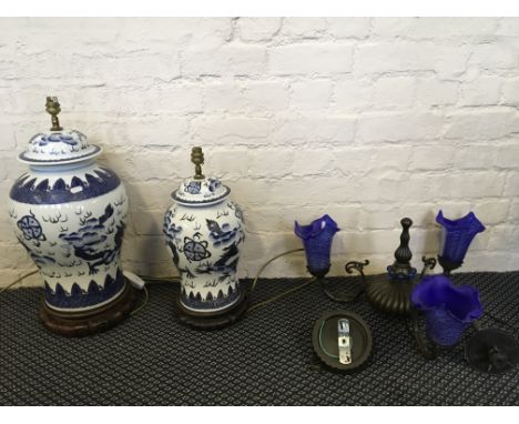 Two Chinese lamp bases together with a three branch chandelier with blue glass light shades.
