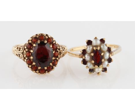 Two hallmarked 9ct yellow gold red stone rings, one additionally set with split pearls, ring size Q and R, (2).