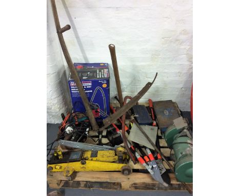A pallet of tools to include a bench grinder and various hand tools.