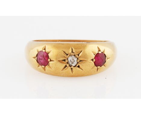 A Victorian 18ct yellow gold ruby and diamond three stone ring, star set with a central old cut diamond, flanked to either si