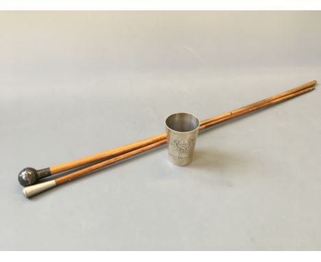 A pair of swagger sticks together with a silver beaker stamped J M Werner 800 224622.