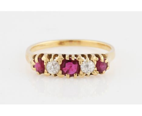 A ruby and diamond five stone ring, set with three graduated cushion cut rubies, spaced with two old cut diamonds, unmarked y