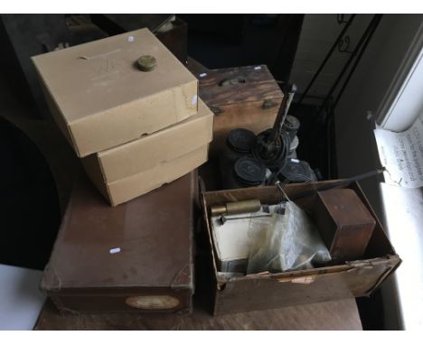 A watch cleaner, a suitcase of model train track and parts, two boxes of clock parts, and three boxes of watch parts.