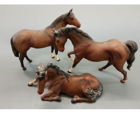 Three Beswick ceramic horses, ( two standing, one lying down).