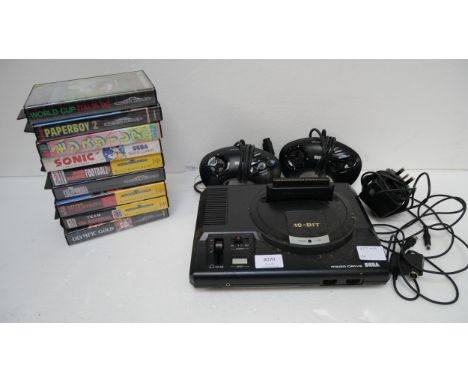 A Sega Mega Drive 16-Bit games console with two control pads, RF Switch, power supply and nine Mega Drive games including Pap