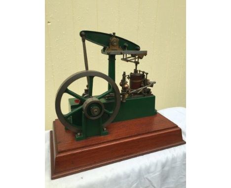 A Stuart Turner beam engine fitted with 'Watt's Parallel Motion Speed Govenor', set on a hardwood base.