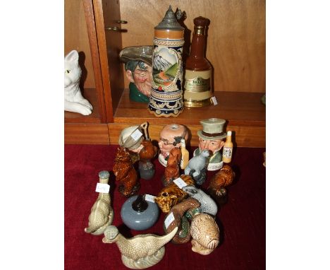A collection of eleven Beswick Beneagles Scotch whisky ceramic bird bottles and a curling stone, average height 10cm, togethe