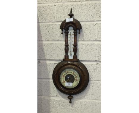 An Edwardian walnut aneroid barometer and thermometer, 55cm high.